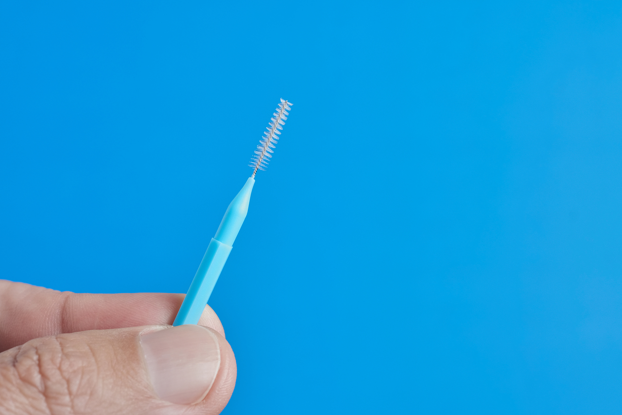 An interdental brush meant to clean between teeth