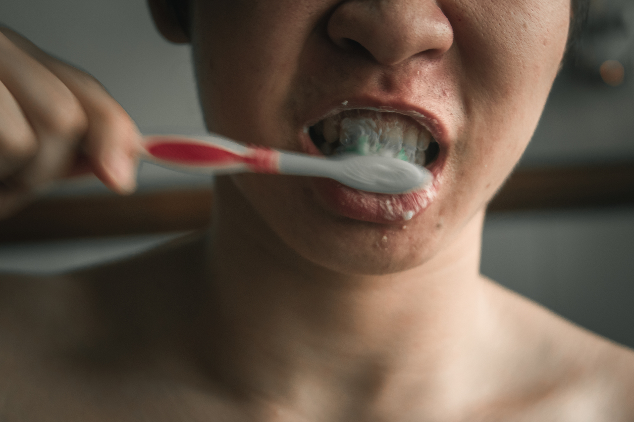Person brushing teeth in a brightly lit room 2026 03 17 17 47 57 utc 1