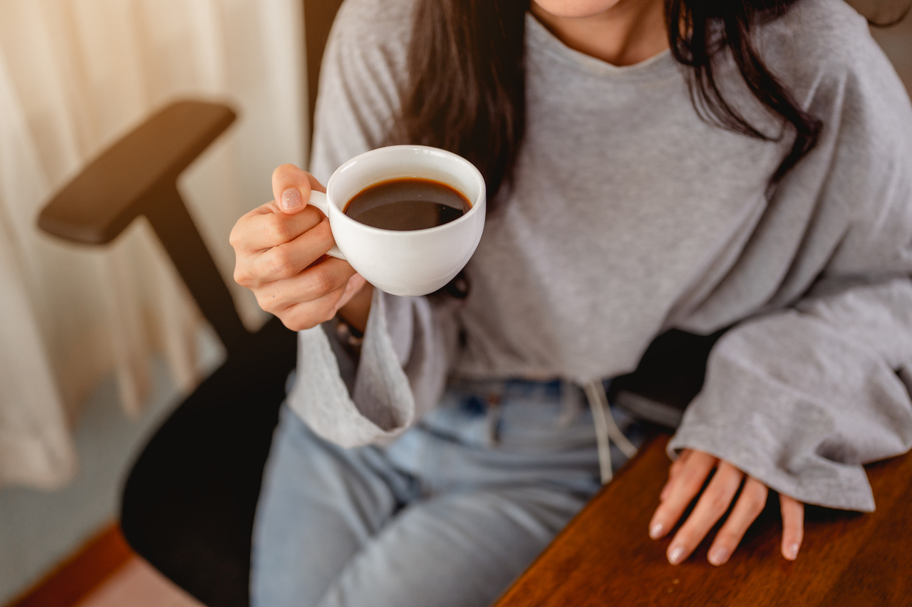 Woman holding a cup of coffee