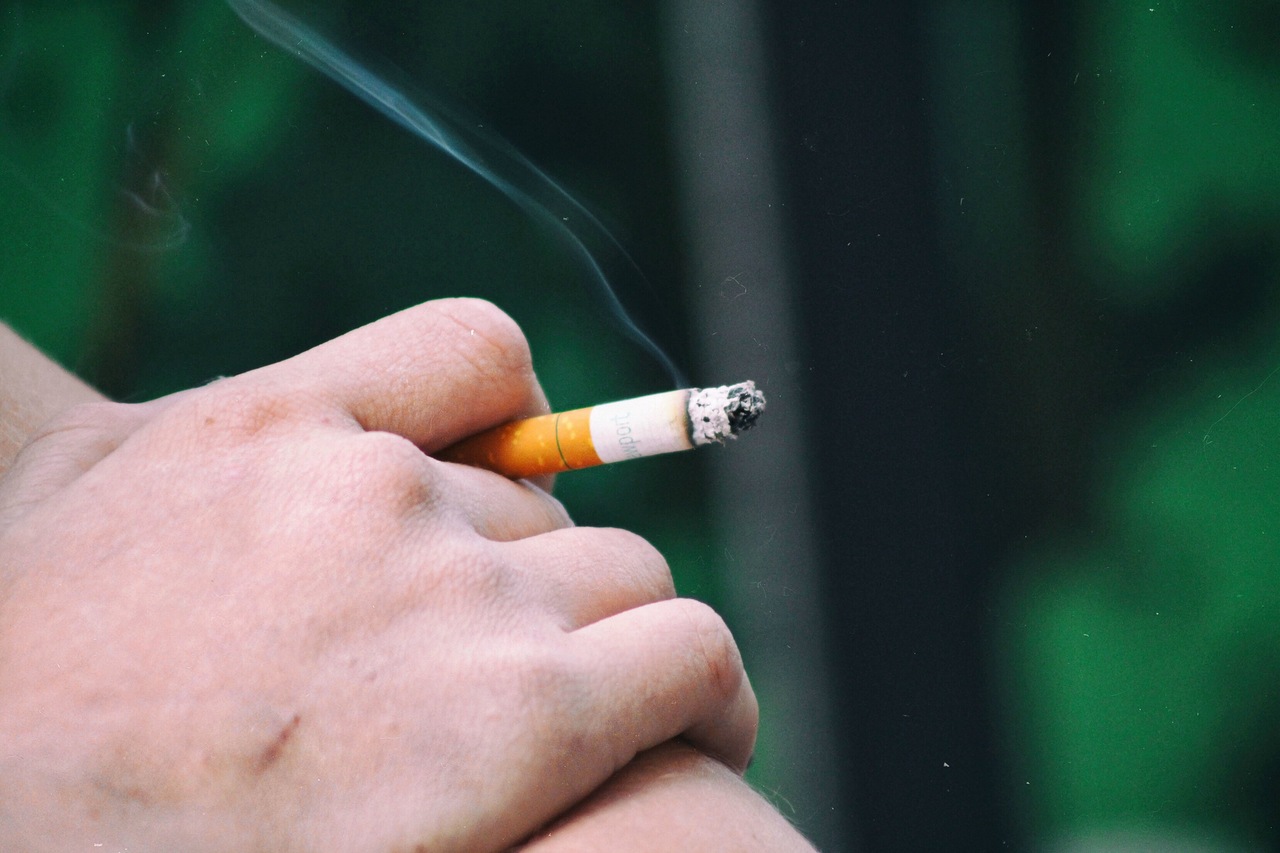 Hand holding a burning cigarette close up 2026 03 16 00 33 27 utc 1