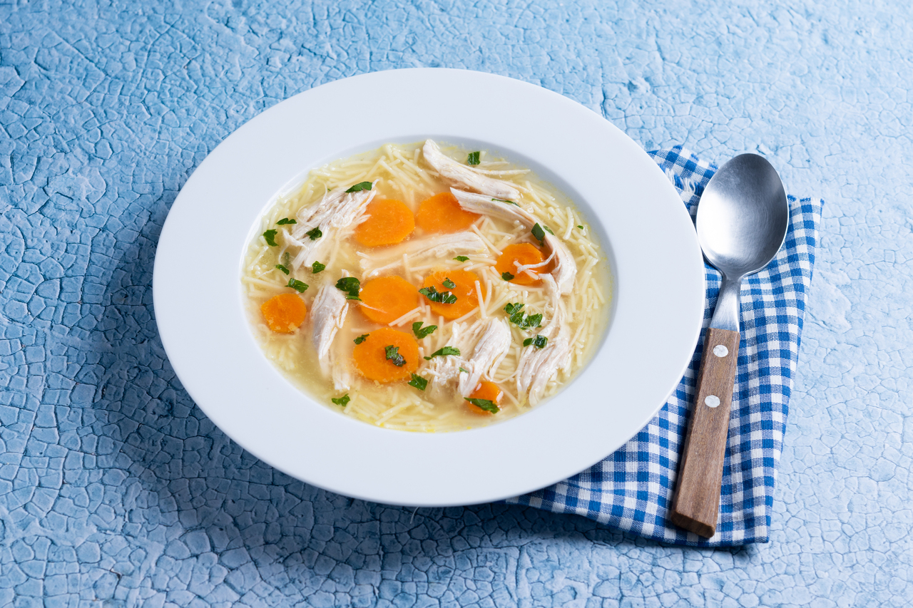 Homemade chicken soup on blue background 2026 03 09 02 51 44 utc 1
