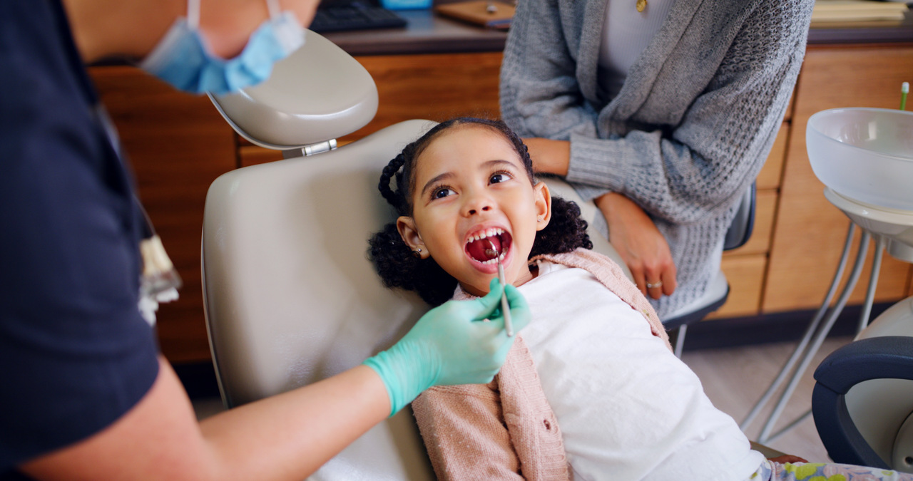 young girl at the dentist getting her teeth checked
